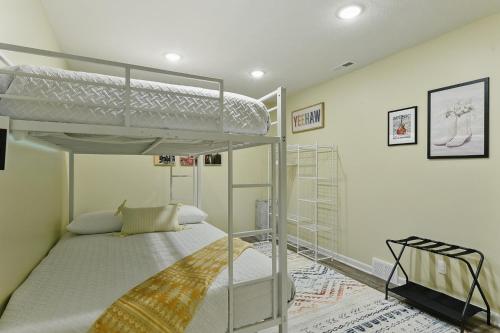 a bedroom with two bunk beds in a room at Spacious Country Farmhouse Retreat, Sleeps 16, Pool, Movie Room in Papillion
