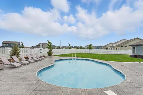 a swimming pool with lounge chairs in a yard at Spacious Country Farmhouse Retreat, Sleeps 16, Pool, Movie Room in Papillion