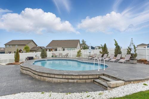 a swimming pool with chairs around it in a yard at Spacious Country Farmhouse Retreat, Sleeps 16, Pool, Movie Room in Papillion