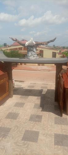 a glass table on top of a building with a view at Jonny City Hotel in Kumasi