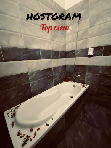 a bathroom with a tub with the words restroom top view at Hostgram Top View in Cairo