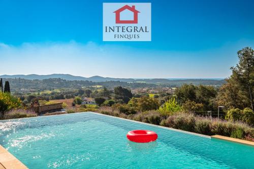 a red frisbee sitting in a swimming pool at Casa les Lutins in Vall-Llobrega