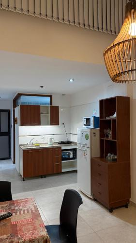 a kitchen with a white refrigerator and a stove at Temporario Alfonso I in Santa Fe