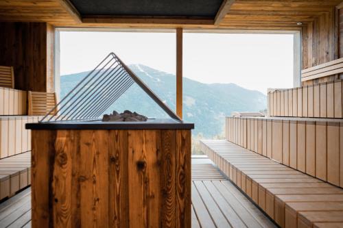 a room with a large window in a wooden building at Puitalm Apartments & SPA by Peak Stay in Arzl im Pitztal