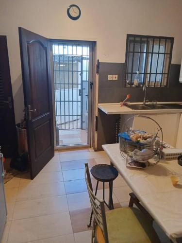 a kitchen with a table with a bowl of food on it at Travellers Ensuites, La Beach Hub in Trofwi