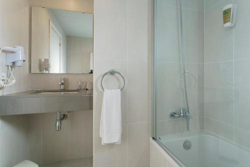 a bathroom with a shower and a sink and a toilet at Minura Sur Menorca in Punta Prima