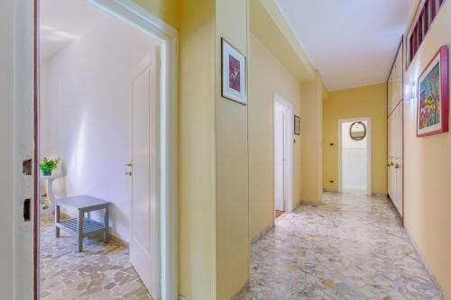 a hallway with yellow walls and a tile floor at Mercato delle Erbe Big Apartment in Bologna