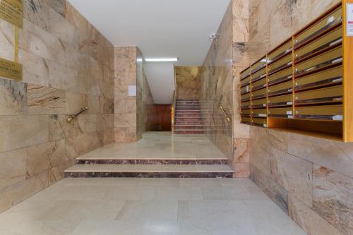 a staircase in a building with a stone wall at Mercato delle Erbe Big Apartment in Bologna