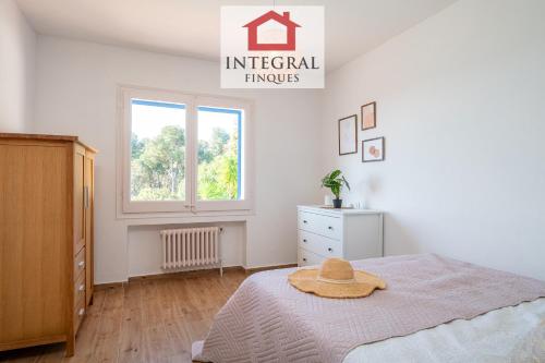 a bedroom with a bed with a hat on it at Casa les Lutins in Vall-Llobrega
