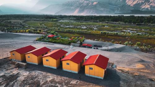 an overhead view of a row of houses with red roofs at The Crescent Resort in Skardu