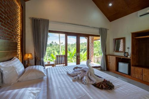 a bedroom with a large bed with a swan on it at Organic Rice Harmony in Tetebatu