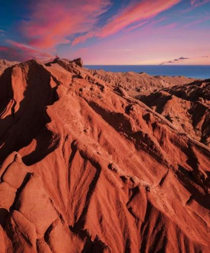 an aerial view of a desert with the ocean at Yurt Camp Town of heavenly mountains " Kyz Zhibek" in Dzhetyoguz