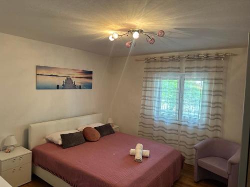 a bedroom with a bed with a teddy bear on it at Apartment King in Senj