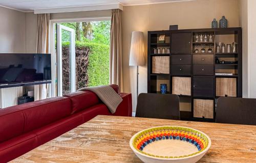 a living room with a table with a bowl on it at 2 Bedroom Nice Home In Ochten in Ochten