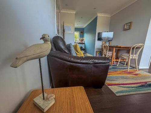 a bird statue on a table in a living room at Chalet For Hire At Rainbows End Near A Beautiful Norfolk Beach Ref 31039R in Bacton