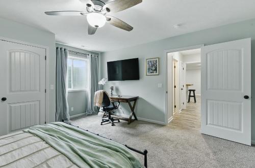 a bedroom with a bed and a ceiling fan at Spacious Country Farmhouse Retreat, Sleeps 16, Pool, Movie Room in Papillion