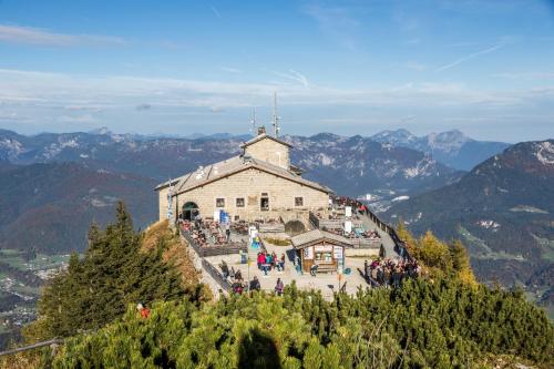 a group of people standing outside of a building on a mountain at Haus Familie Kosper Untersberger Kuschelnest in Bischofswiesen