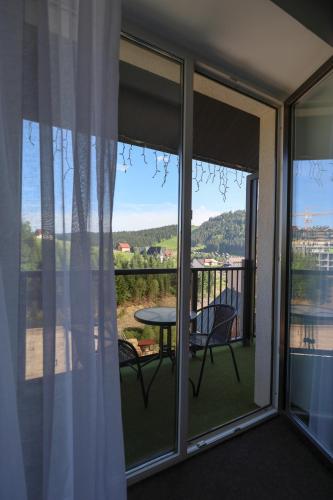 a view of a balcony with a table and chairs at VILSON hotel in Bukovel