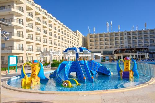 a water park with a water slide in a pool at Le Jardin Aqua Park Resort in Hurghada