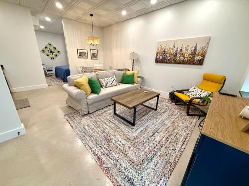 a living room with a couch and a rug at Cozy Cure Apartment in Downtown and Historic Pilot Mountain in Pilot Mountain