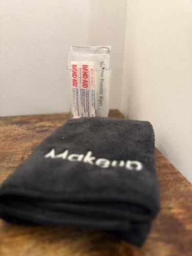 a black towel sitting on a table next to a wall at Cozy Cure Apartment in Downtown and Historic Pilot Mountain in Pilot Mountain