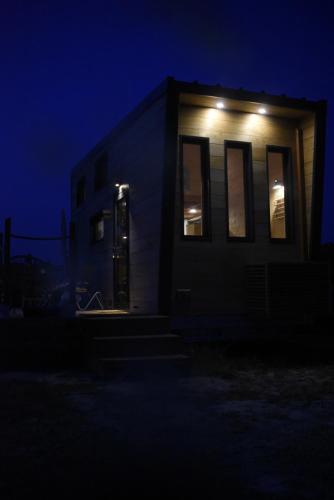 a building with a door in the dark at La Tiny House des Vignes du Château de Vauclaire in Meyrargues