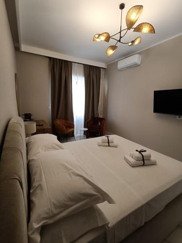 a hotel room with a bed with two towels on it at Luxury Rome Vatican's Garden in Rome