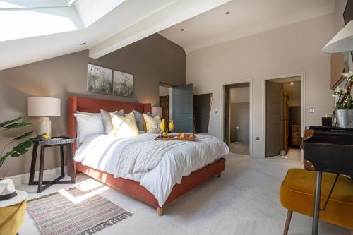 a bedroom with a large bed with a red headboard at Curlew Loft in Lancaster
