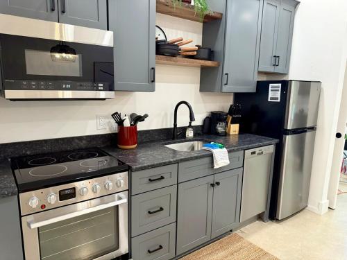 a kitchen with a sink and a stove top oven at Restful Remedy in Downtown & Historic Pilot Mountain Apartment in Pilot Mountain