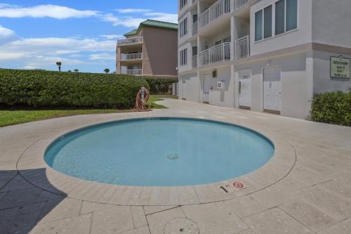 a swimming pool in front of a building at Sail Inn SaintSimons-ground unit beach access pool in East End