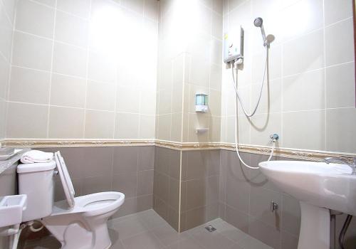 a bathroom with a shower and a toilet and a sink at i Boutique Hotel in Pluak Daeng