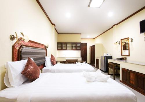 a hotel room with two beds and a kitchen at i Boutique Hotel in Pluak Daeng