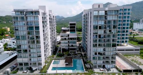 an aerial view of two tall apartment buildings at Comfortable apartment near the beach in Playa Bello Horizonte