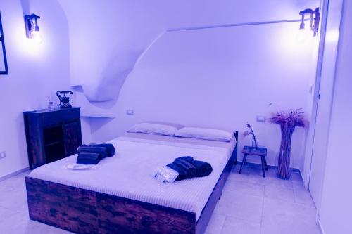a bedroom with a bed with two towels on it at Aca Suite Luxury in Adelfia