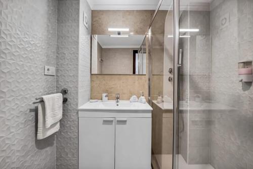 a bathroom with a white sink and a shower at Gata de Gorgos in Gata de Gorgos