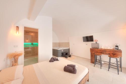 a bedroom with two beds and a desk and a television at Aca Suite Luxury in Adelfia