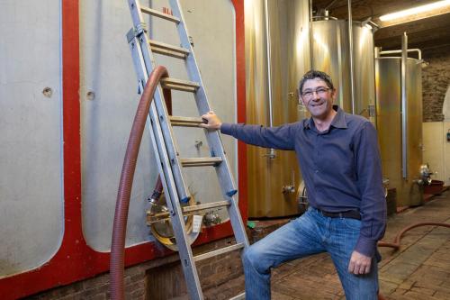 a man is standing next to a ladder at Borgo Villa Certano - Case Vacanza in Toscana in Siena
