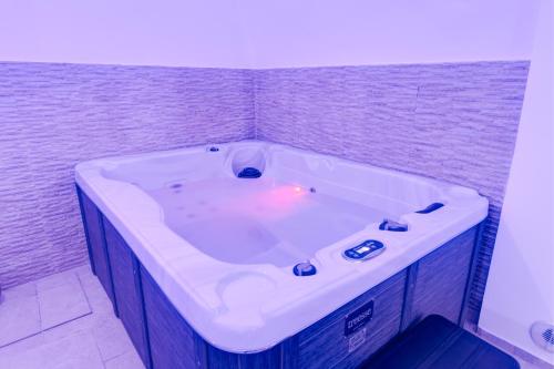 a large bath tub in a room with at Aca Suite Luxury in Adelfia