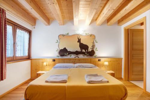 a bedroom with a bed and a painting on the wall at Agriturismo Soleil Levant Torgnon in Torgnon