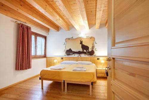 a bedroom with a bed with a picture on the wall at Agriturismo Soleil Levant Torgnon in Torgnon