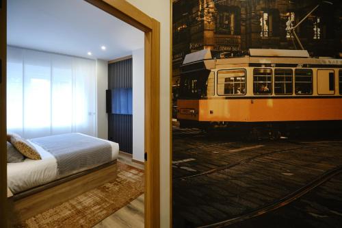 a bedroom with a bed and a train mural at IL FOCOLARE Premium Suites in Avilés