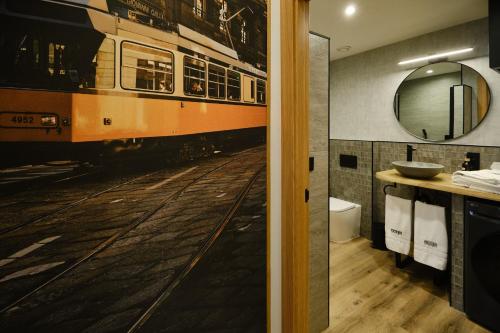 a bathroom with a train on the floor and a mirror at IL FOCOLARE Premium Suites in Avilés