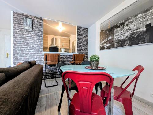 a living room with a table and a couch at Chic apart with bar in Paris in Saint-Denis