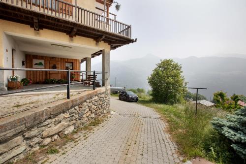 a car parked on a road next to a building at Agriturismo Soleil Levant Torgnon in Torgnon