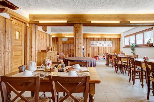 a dining room with wooden tables and chairs at Agriturismo Soleil Levant Torgnon in Torgnon