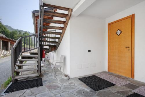 a staircase leading to a room with a wooden door at Agriturismo Soleil Levant Torgnon in Torgnon