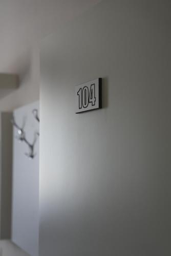 a clock on a wall with the number at BluePoint Hotel in Tepelenë
