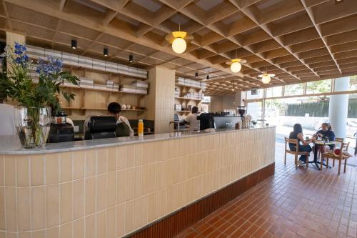 a restaurant with people sitting at tables at The Tropicana Hotel in Cape Town
