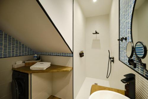 a bathroom with a sink and a toilet and a staircase at IL FOCOLARE Premium Suites in Avilés