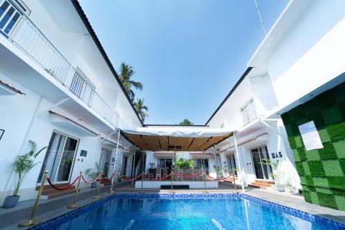 an exterior view of a building with a swimming pool at Code Red Resort in Morjim
